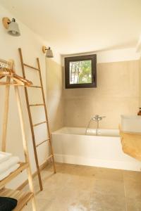 a bathroom with a ladder and a bath tub at La Bergerie du Roy-Chambres D'hôtes- in Rognes