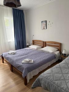 a bedroom with two beds with towels on them at Guest house Me and grandfather-მე და პაპა in Dedoplis Tskaro