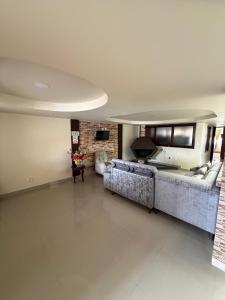 a living room with two couches and a fireplace at Hostal Brooklyn in Ipiales