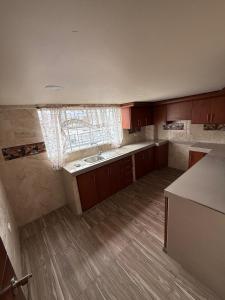 an empty kitchen with a sink and a window at Hostal Brooklyn in Ipiales +12 photos