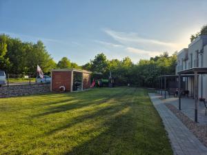 a large yard with a building and a shed at Domki California in Jastrzębia Góra +79 photos