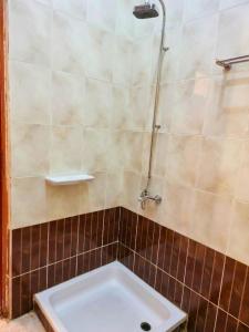 a shower with a white tub in a bathroom at شاليه العميد chalet in Marsa Matruh +12 photos