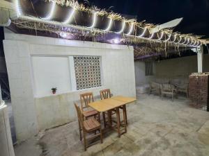 a room with a table and chairs and lights at شاليه العميد chalet in Marsa Matruh