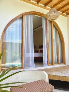 a room with a large window with a bed at Laya Boutique Hotel in General Luna