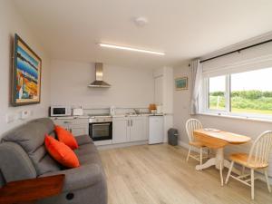 a living room with a couch and a table at Radharc an Hook Estuary Bliss in Duncannon