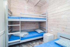 a bedroom with bunk beds in a room with wooden walls at Greckie Domki ZEUS in Stegna +15 photos