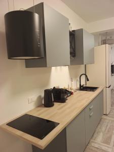 a kitchen with white cabinets and a counter top at Amunì Guest House in Carini +21 photos