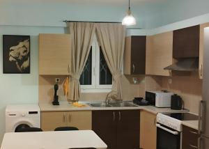 a kitchen with a sink and a microwave at Relaxing home 80m from the sea in Perea +10 photos