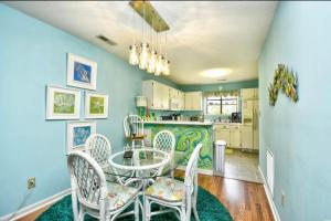 a dining room with a table and chairs and a kitchen at Nice N Myrtle beach house in Little River