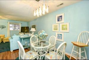 a blue living room with a table and chairs at Nice N Myrtle beach house in Little River