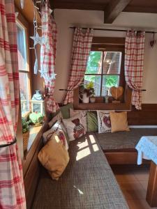 a doll house with a couch and a window at Chata DOBROTKA in Liptovský Mikuláš