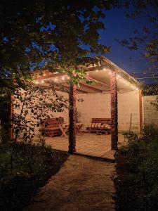 a pergola with lights on a patio at night at STEPANAVAN guesthouse in Stepʼanavan