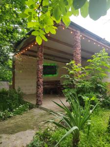 a patio with a bench and lights on it at STEPANAVAN guesthouse in Stepʼanavan +4 photos