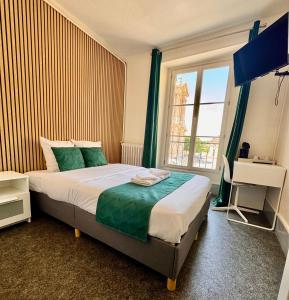 a bedroom with a large bed with a window at L’ESPERANCE in Versailles +62 photos