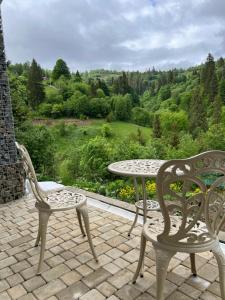a patio with two chairs and a table with a view at LAVANDA hotel club in Slavske