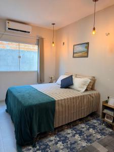 a bedroom with a large bed in a room at Chalé Arandu in Santo Amaro +21 photos