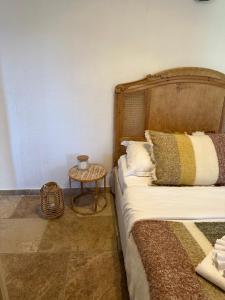 a bedroom with a bed and a side table at BERGERIE A Murta, Domaine de l Ogliastru in Olmeto