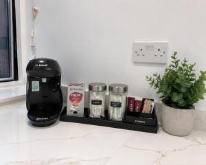 a black coffee maker on a shelf in a kitchen at Barnet Luxe 2 Bedroom Penthouse in Barnet