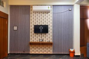 a room with a wall with a tv on a wall at Hotel Maharana Inn in Sehore