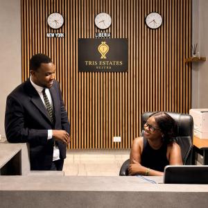 a man and a woman sitting at a table at Tris Estates Hotel & Suites in Dwarzohn