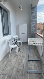a patio with a table and chairs on a balcony at Camera in centro storico in Olbia