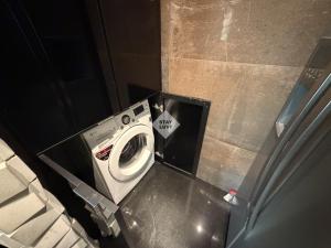 a washer and dryer in a small bathroom at Ville Celestine Condo Hotel 704 in Belo Horizonte