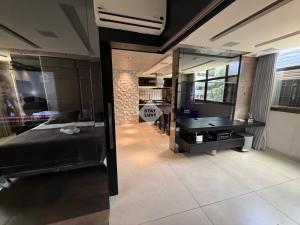 a bedroom with a bed and a pool table at Ville Celestine Condo Hotel 704 in Belo Horizonte