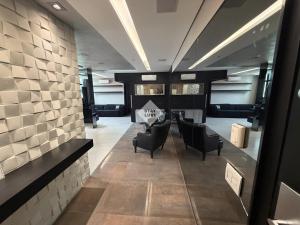 a lobby with chairs and a table in a building at Ville Celestine Condo Hotel 704 in Belo Horizonte