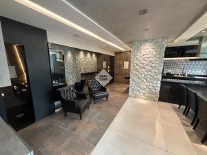 a lobby with chairs and a bar in a building at Ville Celestine Condo Hotel 704 in Belo Horizonte +35 photos