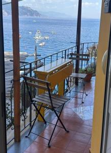 a table and chairs on a balcony overlooking the ocean at Casa Reginella - Borgo Marinaro in Conca dei Marini
