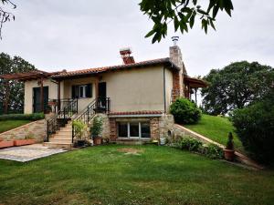 a house with a staircase in front of a yard at Villa Trifylli in Mesimvría