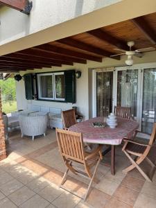 a patio with a table and chairs on a patio at Villa Trifylli in Mesimvría