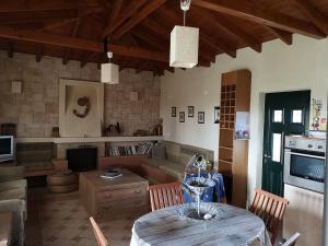 a kitchen and living room with a table and a couch at Villa Trifylli in Mesimvría