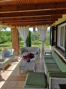 a patio with couches and chairs on a patio at Villa Trifylli in Mesimvría +24 photos