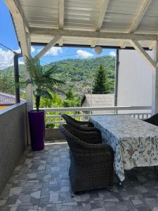 a table and chairs on a balcony with a view at Vila zvjezda 2 in Jajce
