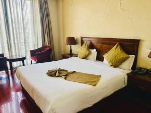 a hotel room with a large bed with gold pillows at Foyat Hotel in Addis Ababa +29 photos