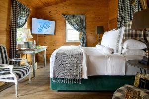 a bedroom with a bed and a table and a chair at Hotel Lulu in Round Top +64 photos