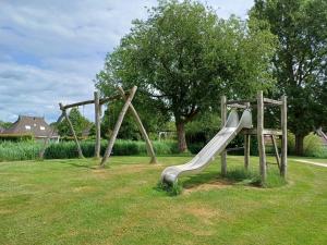 a playground with a slide in a park at Oevr652 in Earnewâld