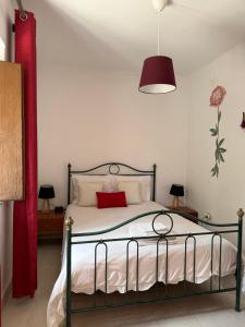 a bedroom with a bed with a red pillow at MONTE DA ADEGA in Vale de Água