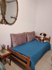 a teddy bear sitting on a bed in a room at Isthmus Filoxenia in Isthmia +16 photos