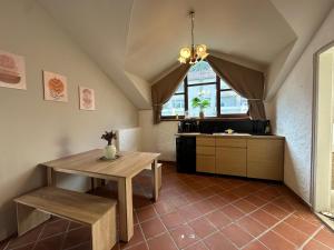 a kitchen with a table and a table and a counter at Honor-Penthouse in Linz