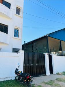 a motorcycle parked in front of a building at The Wink apartments in Malindi