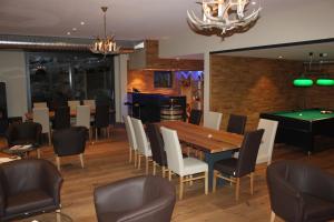 una sala da pranzo con tavolo da ping pong e biliardo di Hotel Restaurant Zur alten Gasse a Bellwald