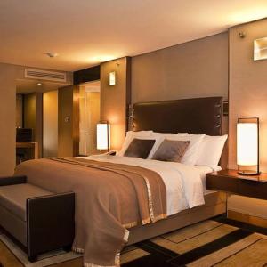 a large bedroom with a large bed with two lamps at Beach hostel in Marsa Alam City
