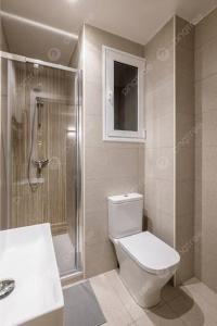 a bathroom with a toilet and a shower and a sink at Beach hostel in Marsa Alam City