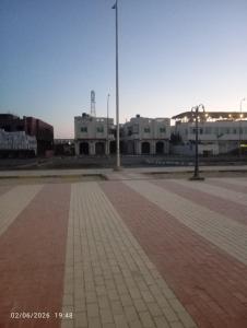 an empty parking lot with buildings in the background at Beach hostel in Marsa Alam City