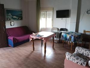 a living room with a couch and a table at Casita del Romero Ronda in Ronda