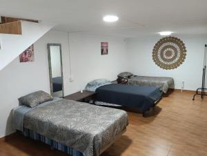 a bedroom with two beds and a mirror at Casita del Romero Ronda in Ronda +13 photos