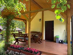 a wooden pergola with a table and bench on a patio at Gąsiorówka in Gryżyna +27 photos