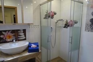 a bathroom with a sink and a shower at Terezia-Appartements Nassfeld in Hermagor +133 photos